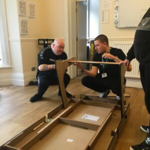 Resident and team member constructing pool table