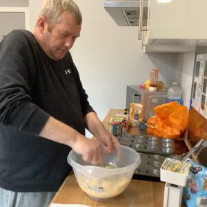 males mixing cupcake batter with hands