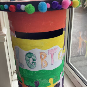 post box decorated in rainbow colours and pom poms