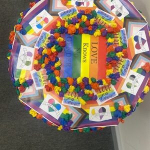 post box lid decorated with rainbows and pom poms