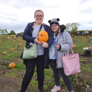 Two residents with a pumpkin