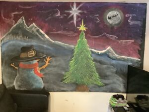 resident drawing of snowman looking at a christmas tree