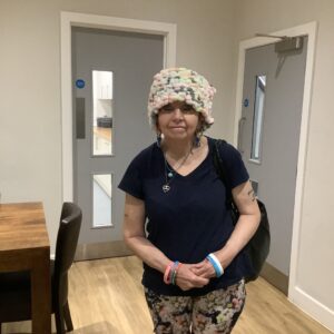 resident wearing a hat that she made