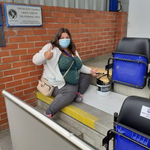 resident painting stairs at football stadium