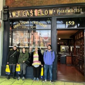 Four residents outside old fashioned pharmacy