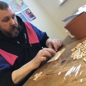 resident making Scrabble picture frame