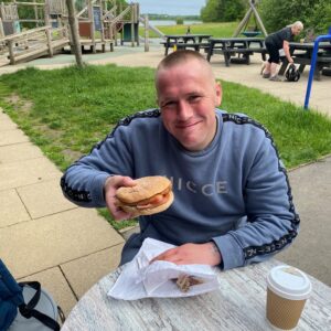 male holding bacon butty