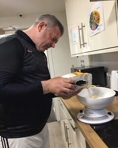 resident pouring flour into measuring bowl