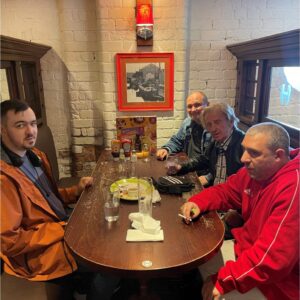 residents around brown wooden table