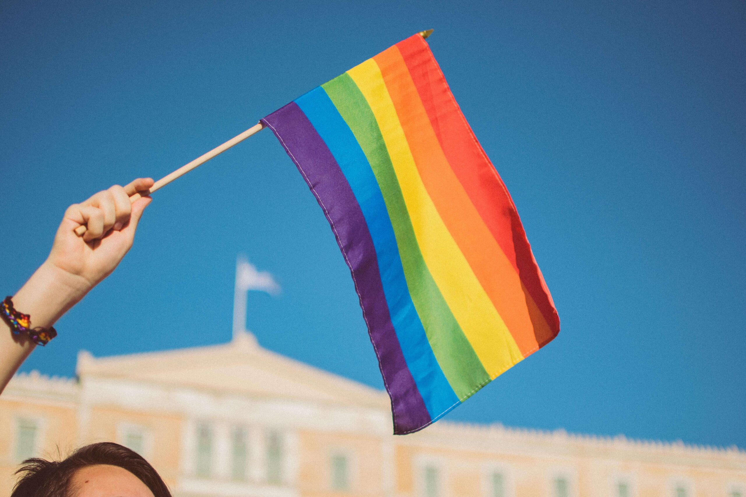 Rainbow Pride Flag against a blue sky