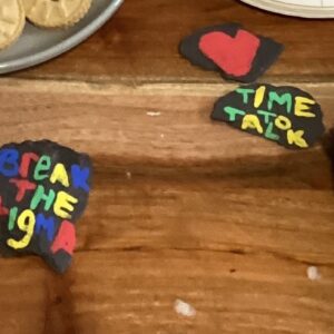 painted rocks that say "time to talk" and "break the stigma"