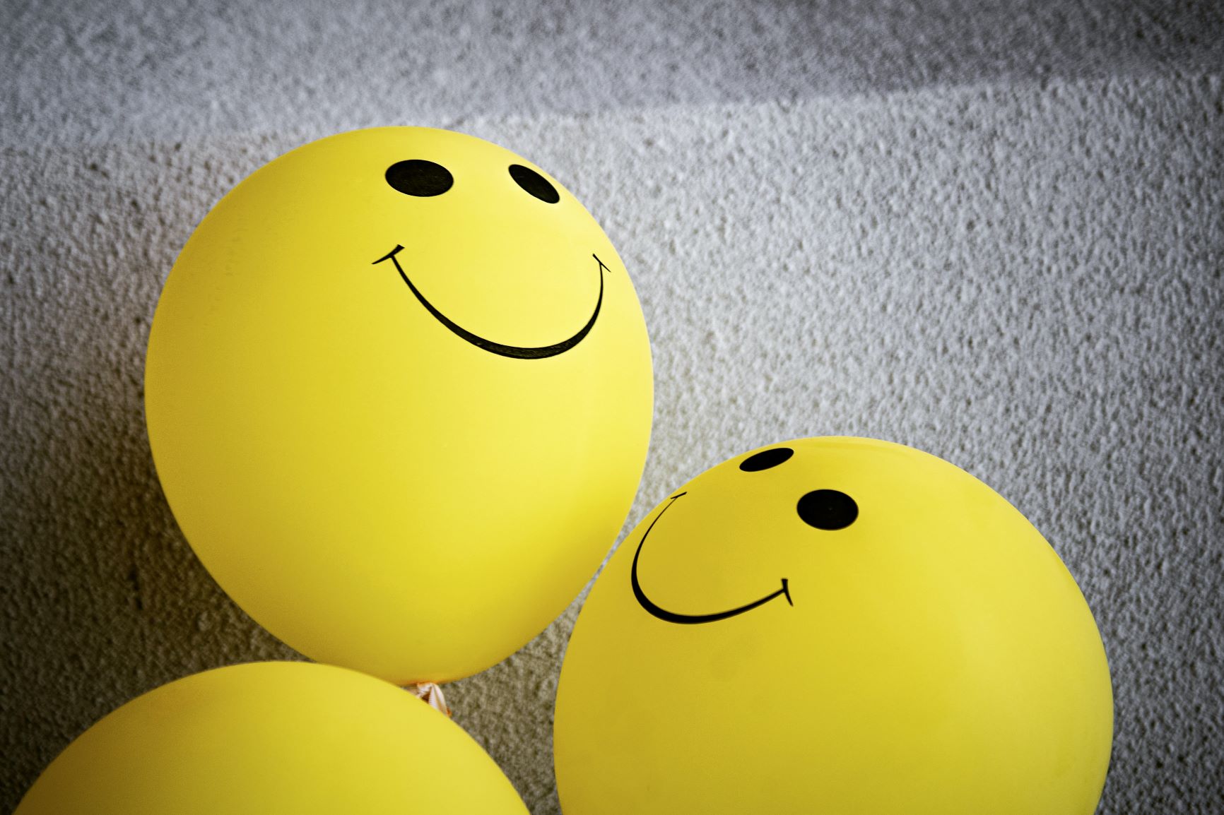 yellow balloons with smiley faces