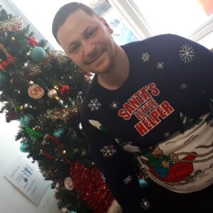 resident wearing christmas jumper