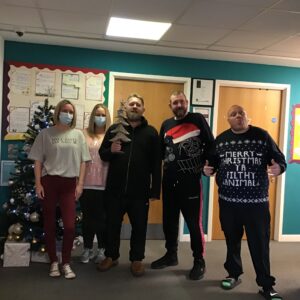 team members and residents wearing christmas jumpers