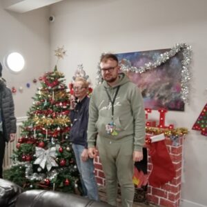 residents standing next to Christmas tree