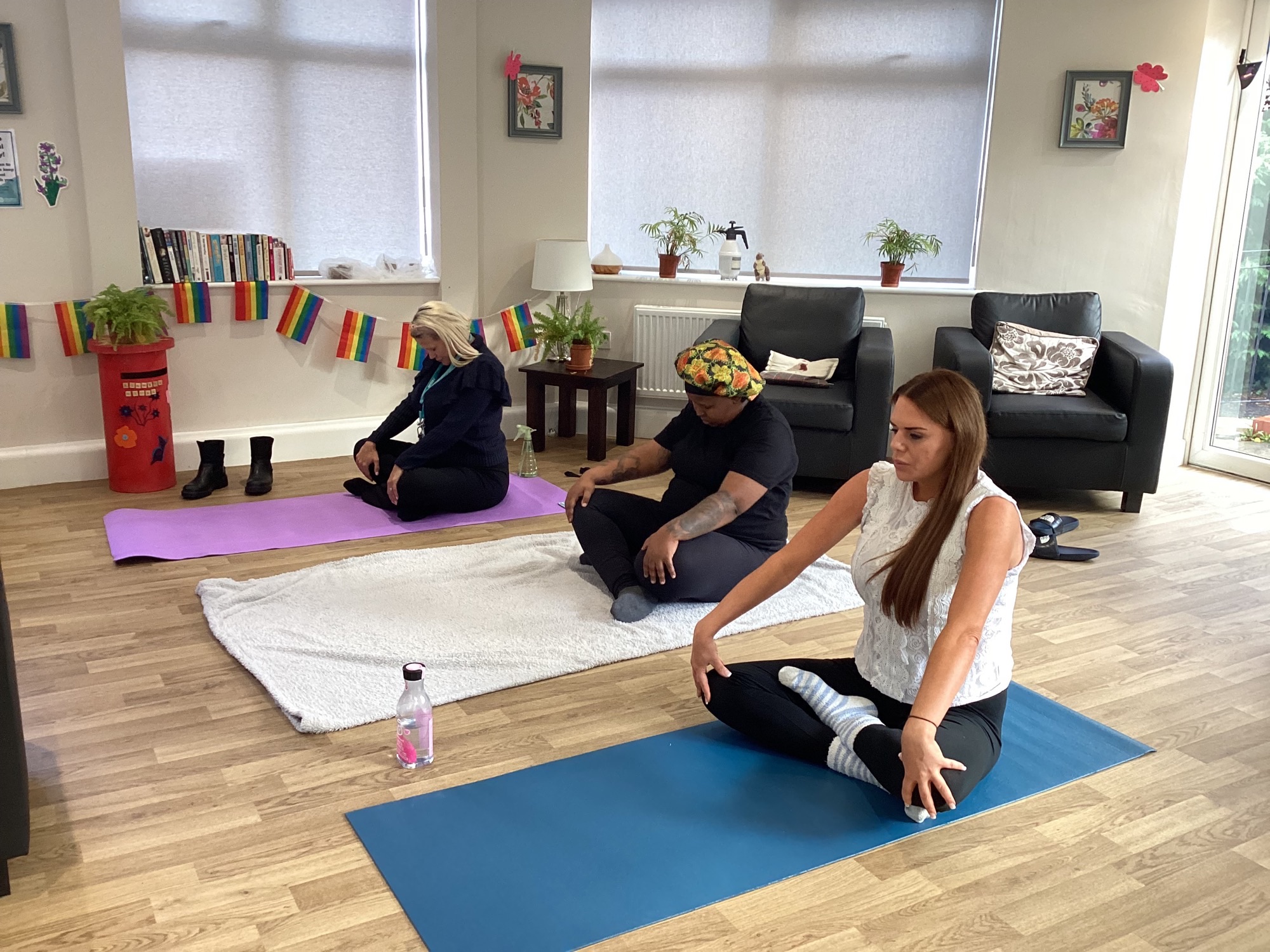 residents and team members in seated yoga pose