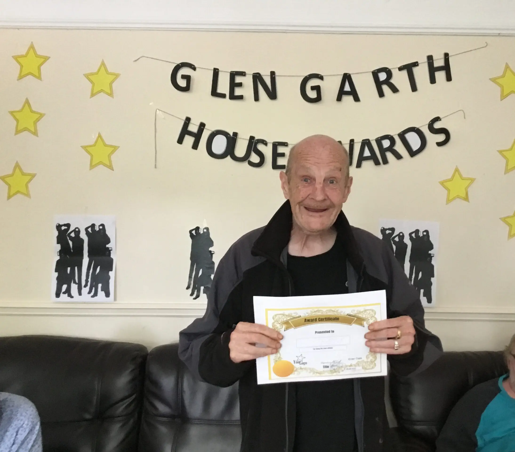 resident with award certificate