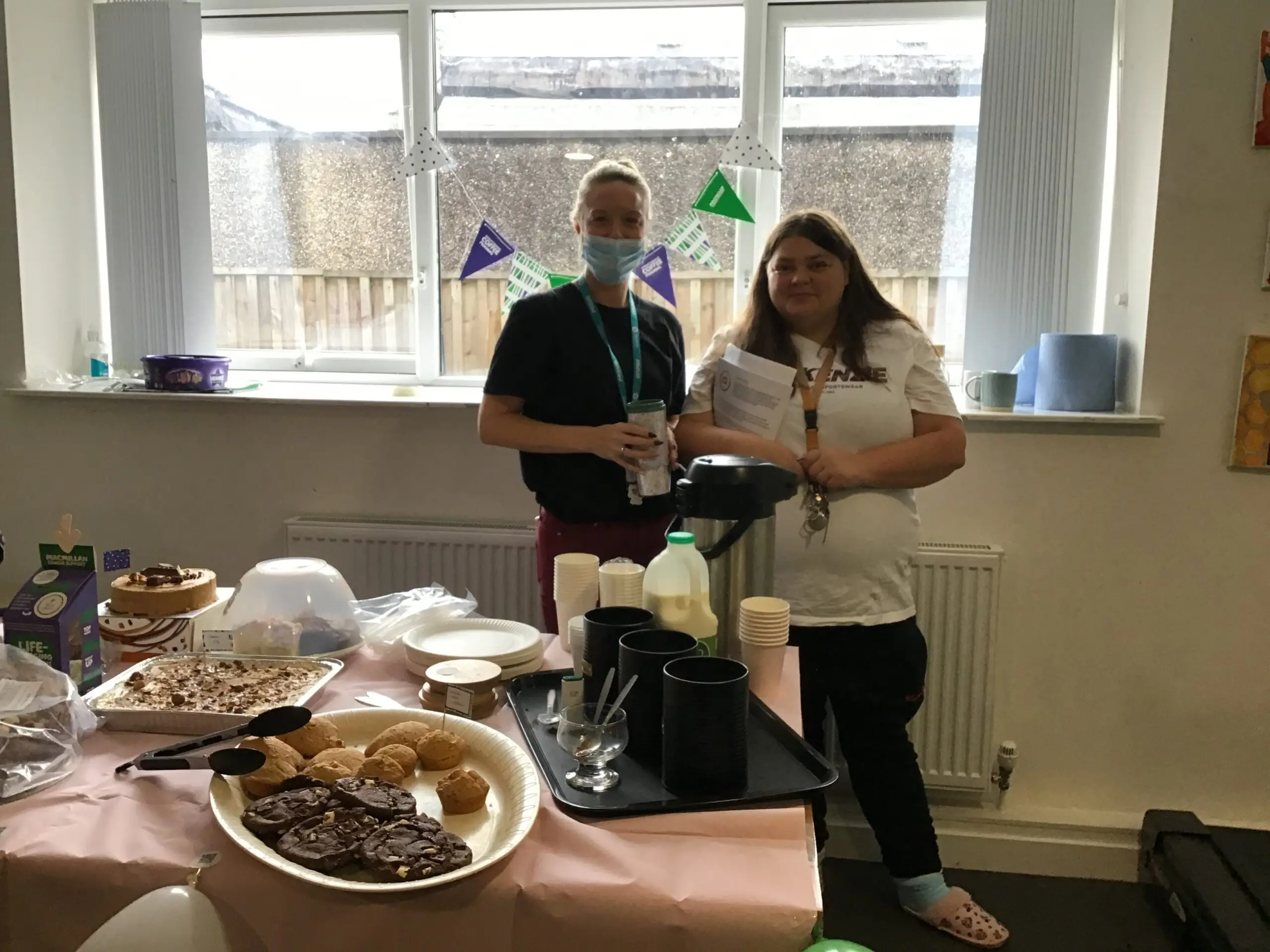 resident and team member in front of buffet spread