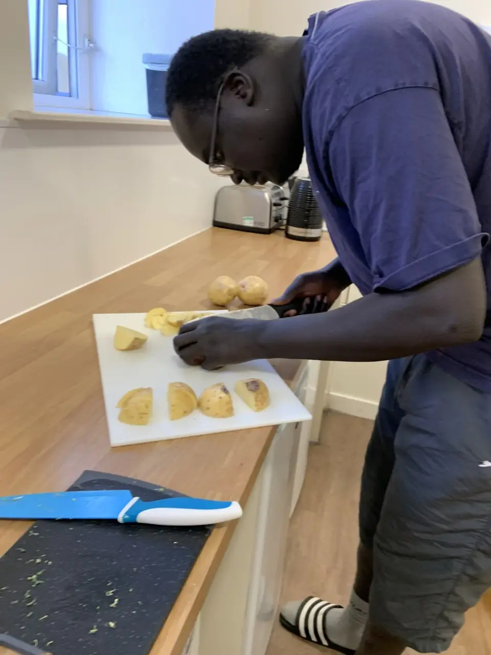 resident chopping potatoes