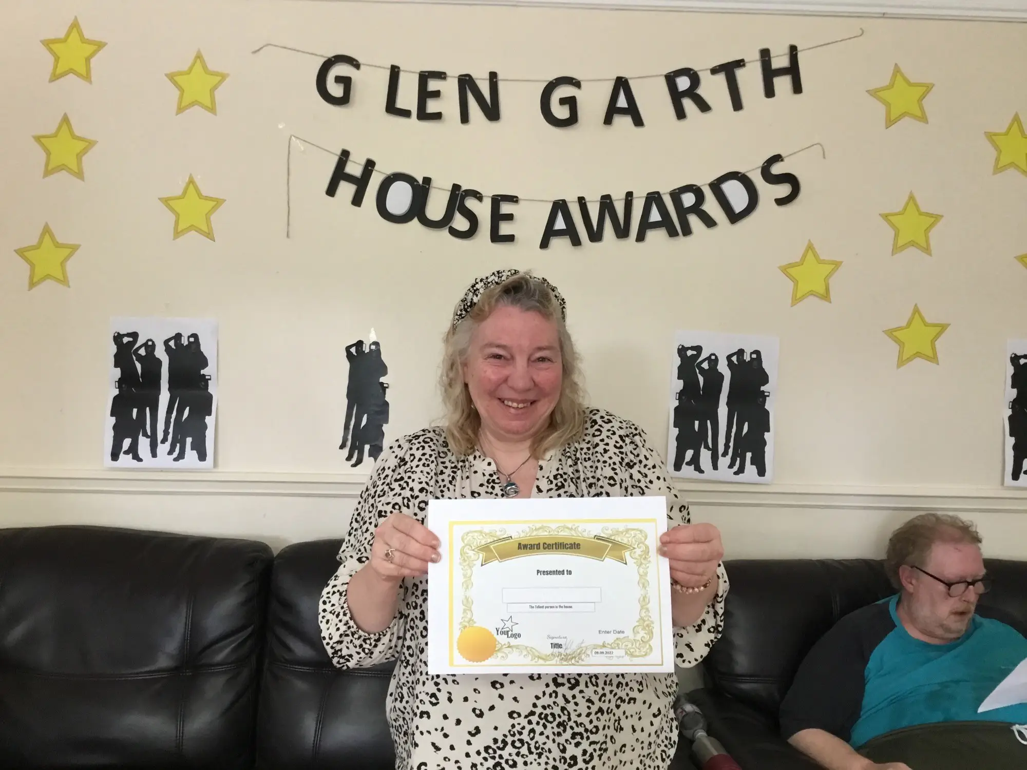 resident with award certificate