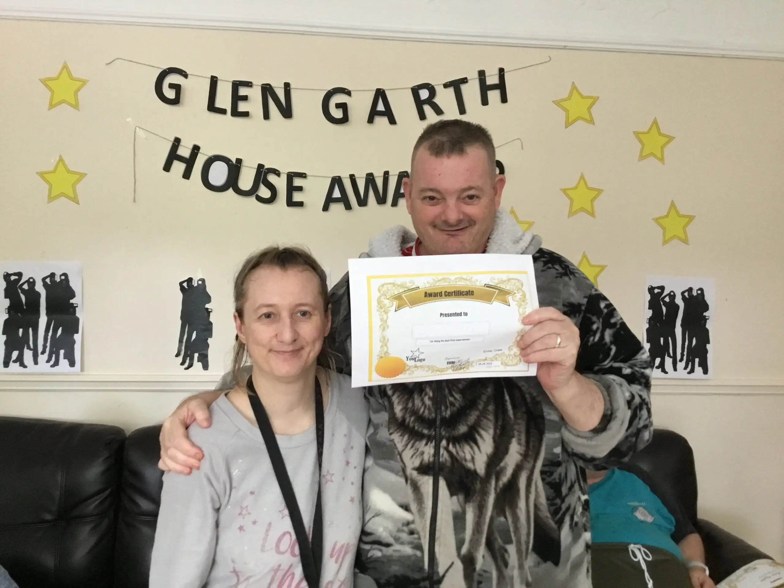 resident with award certificate