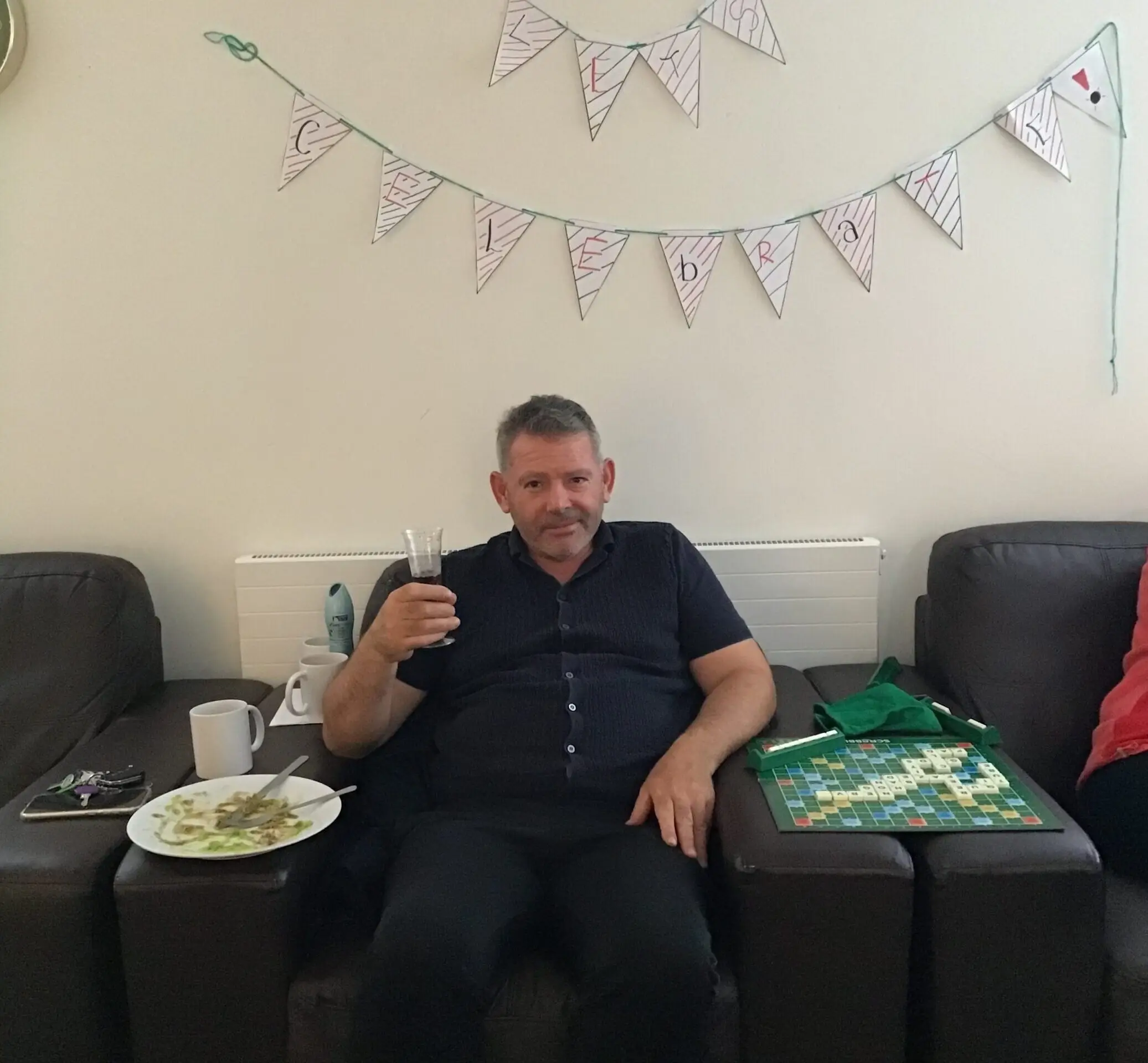 resident sitting on couch with thumbs up