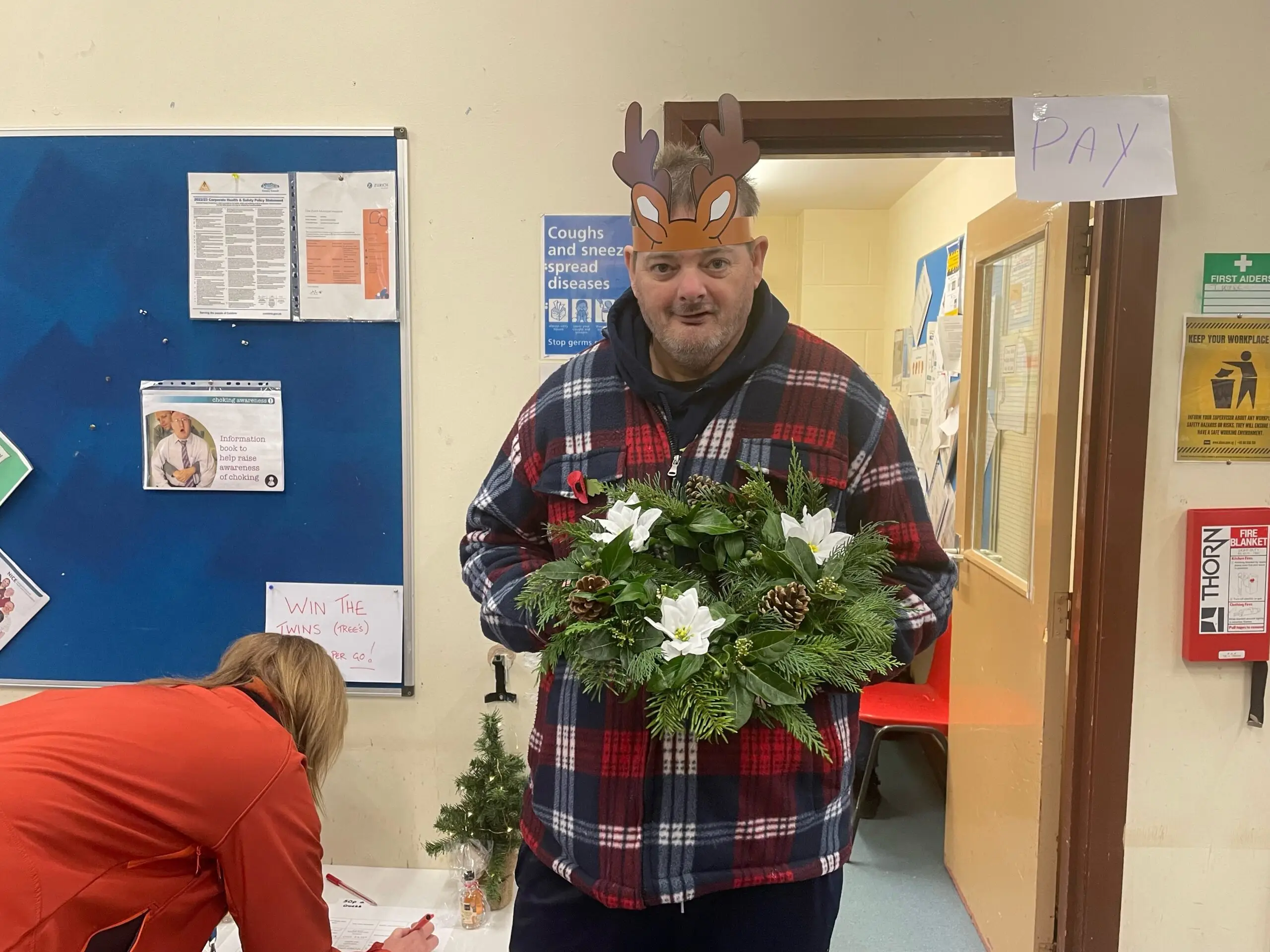 resident holding Christmas wreath