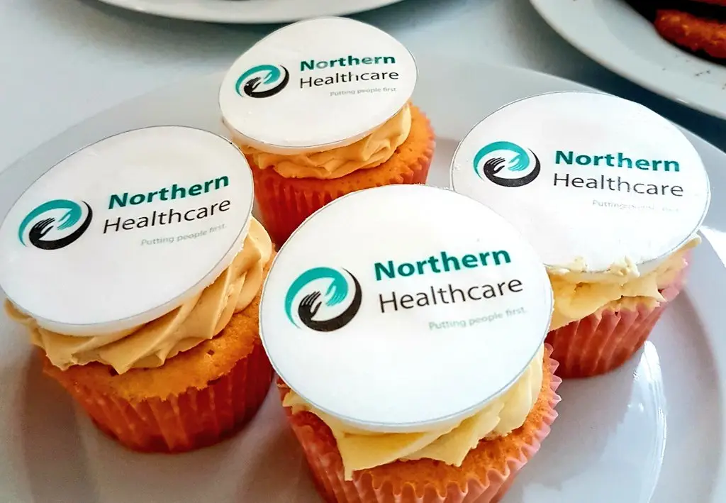 resident adding icing to cake