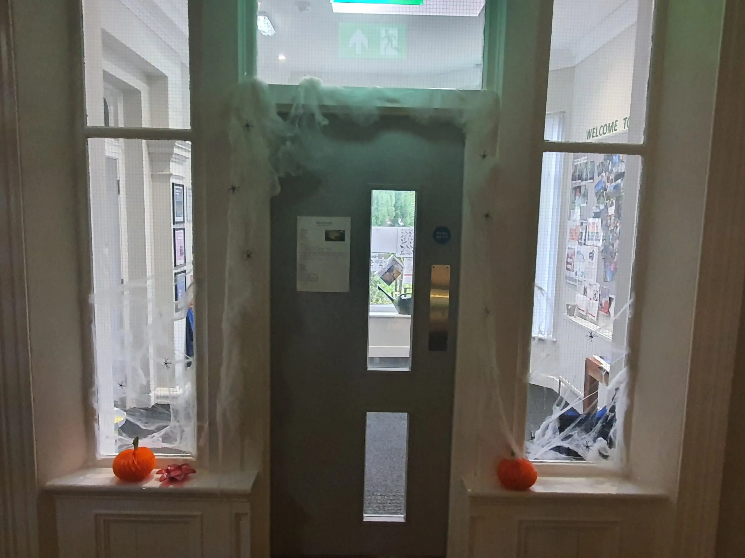 Radcliffe House Halloween decorations: door frame surrounded by pumpkins and fake cobwebs