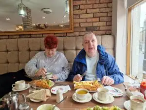 female and male resident enjoying fish and chips