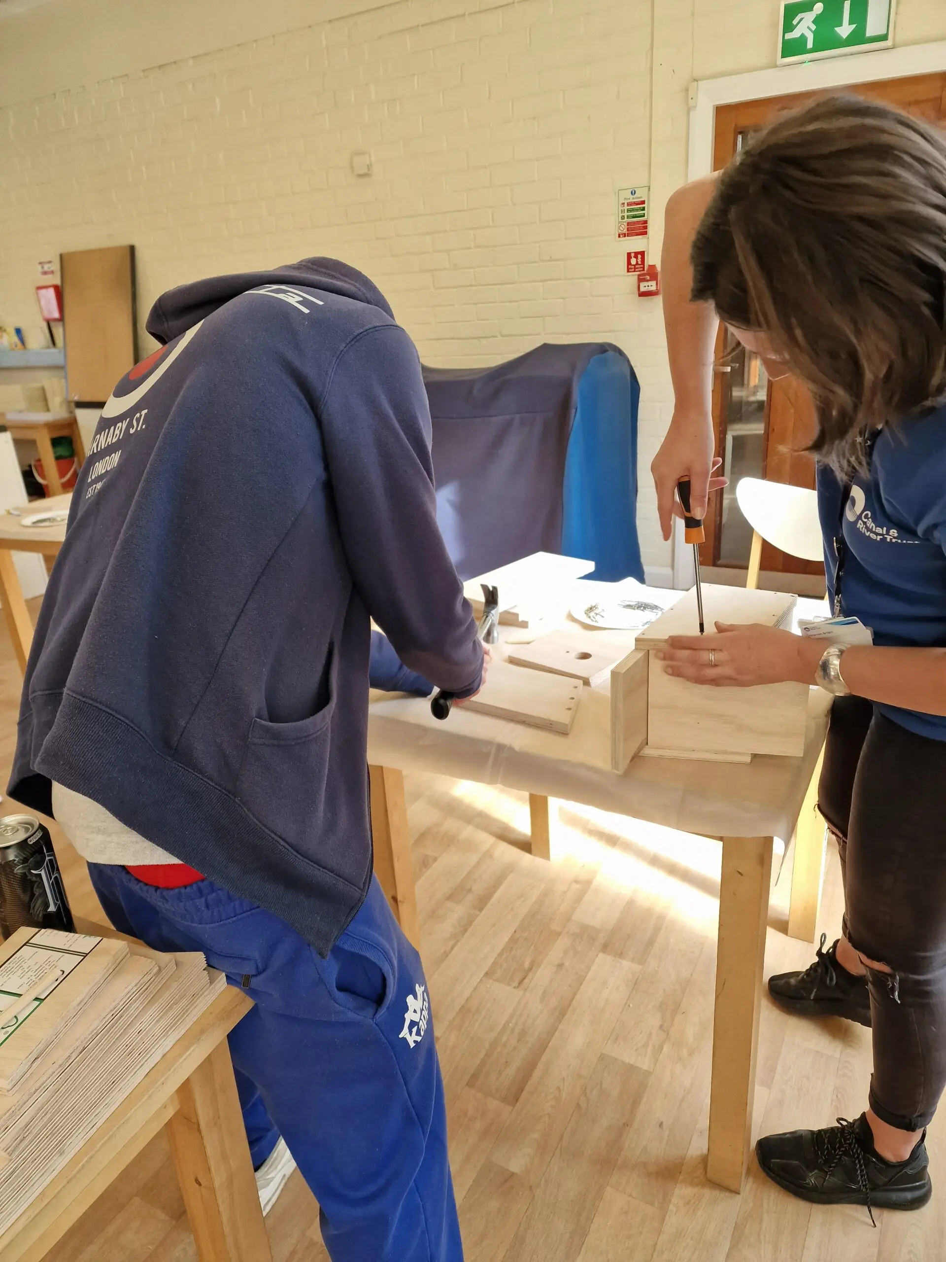 male and female making bird box