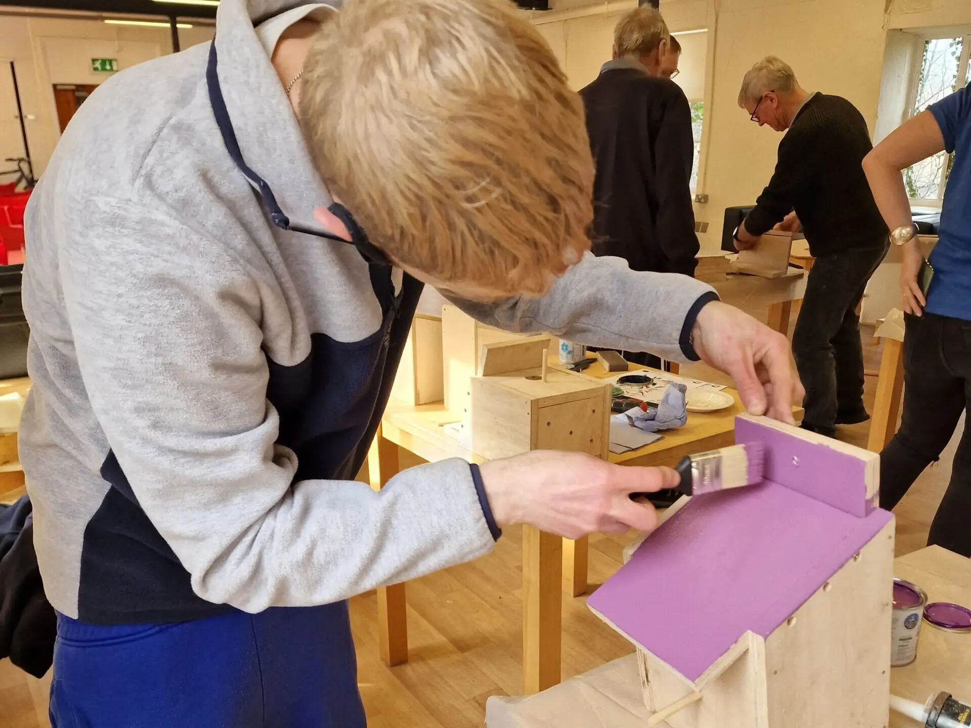 painting the roof of the wooden bird box purple