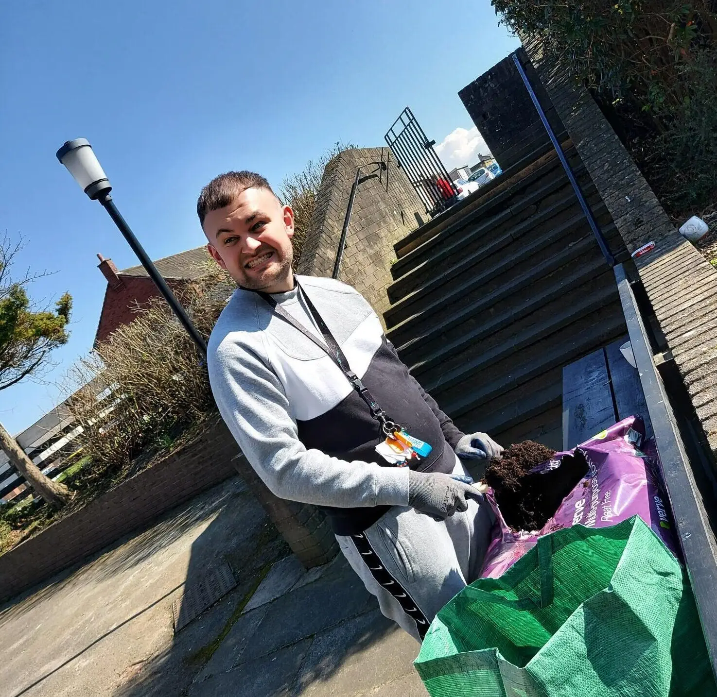 resident holding bag of soil