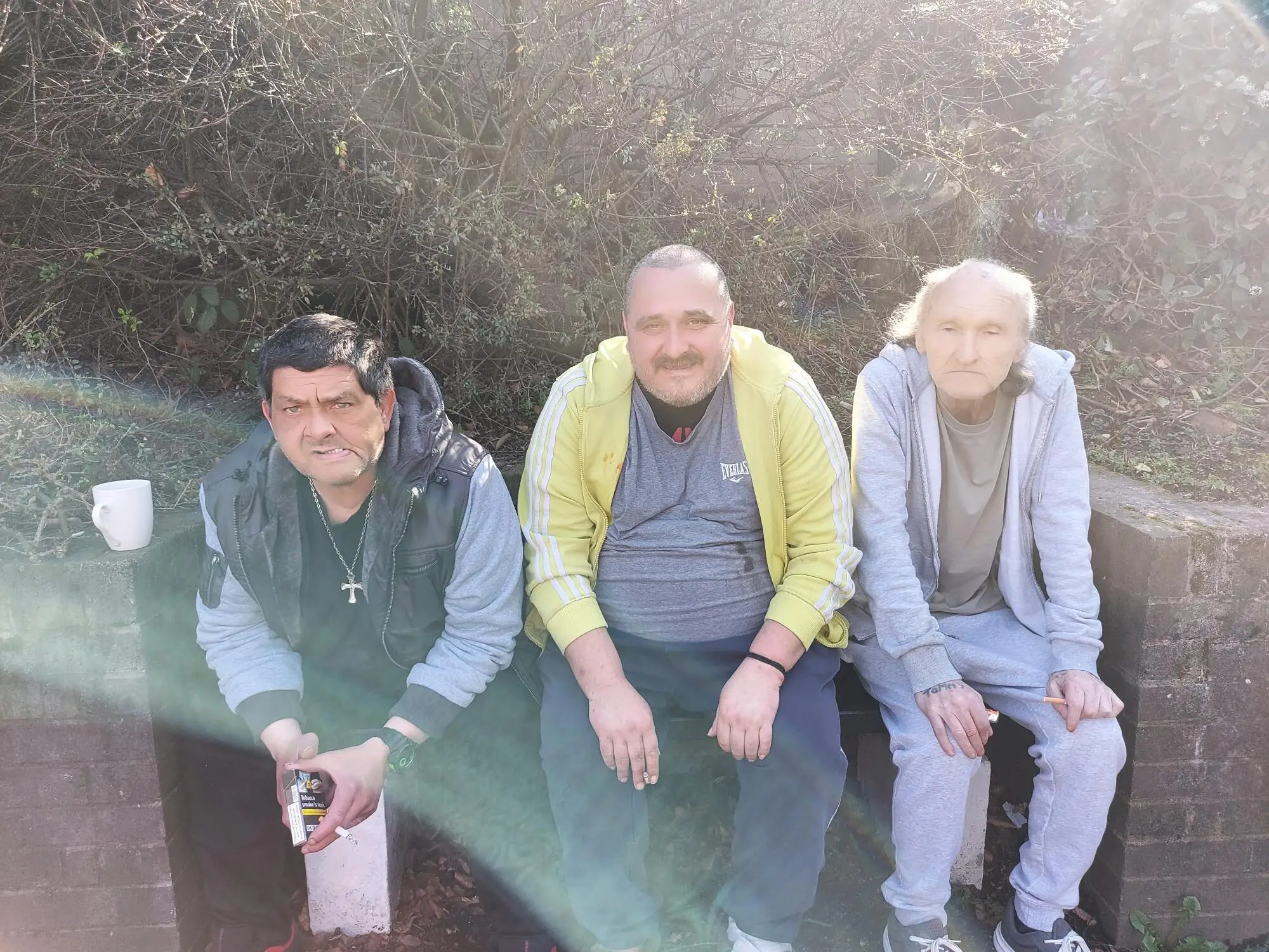 3 male residents sat on bench