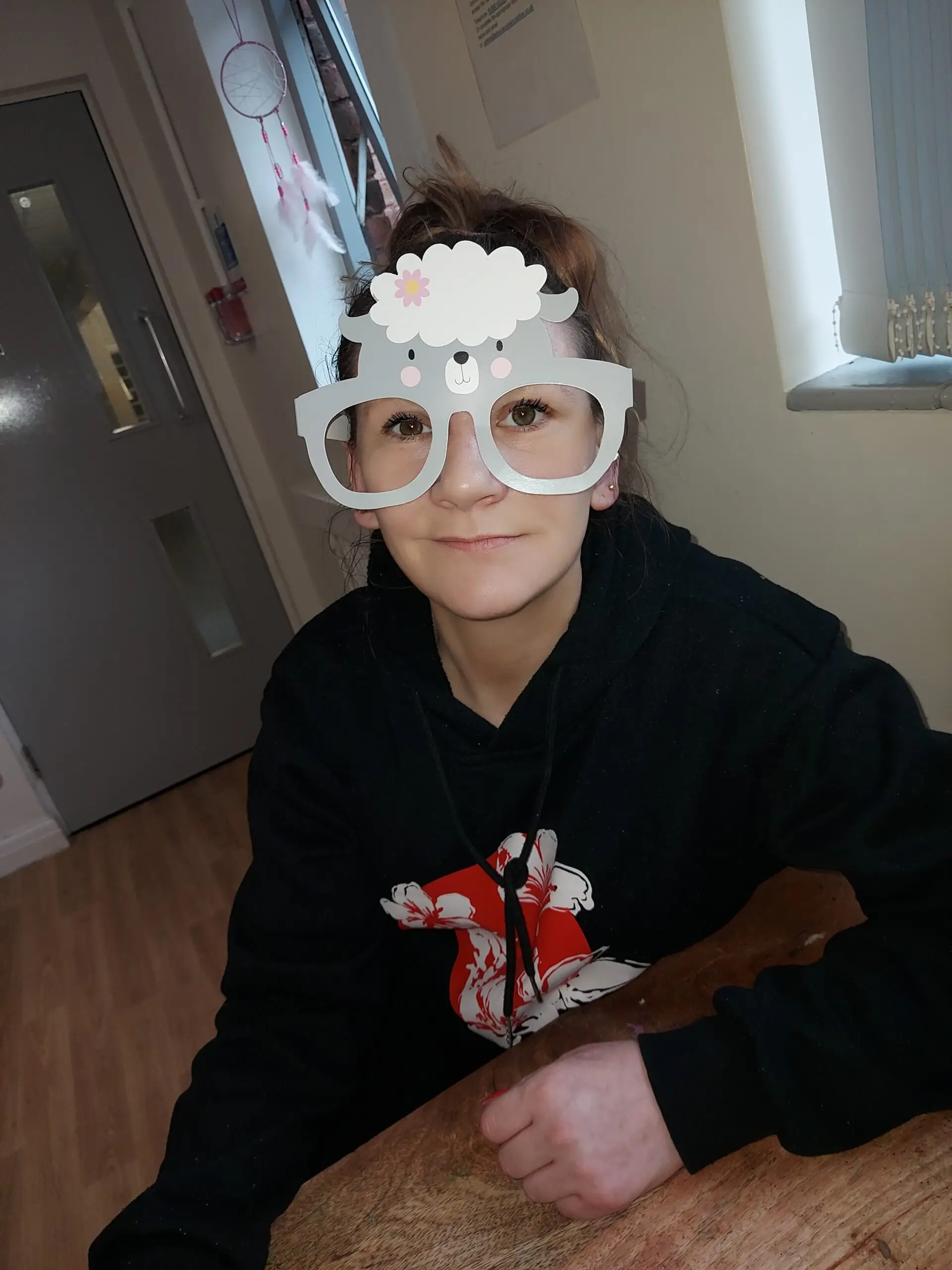 female in black jumper with easter glasses