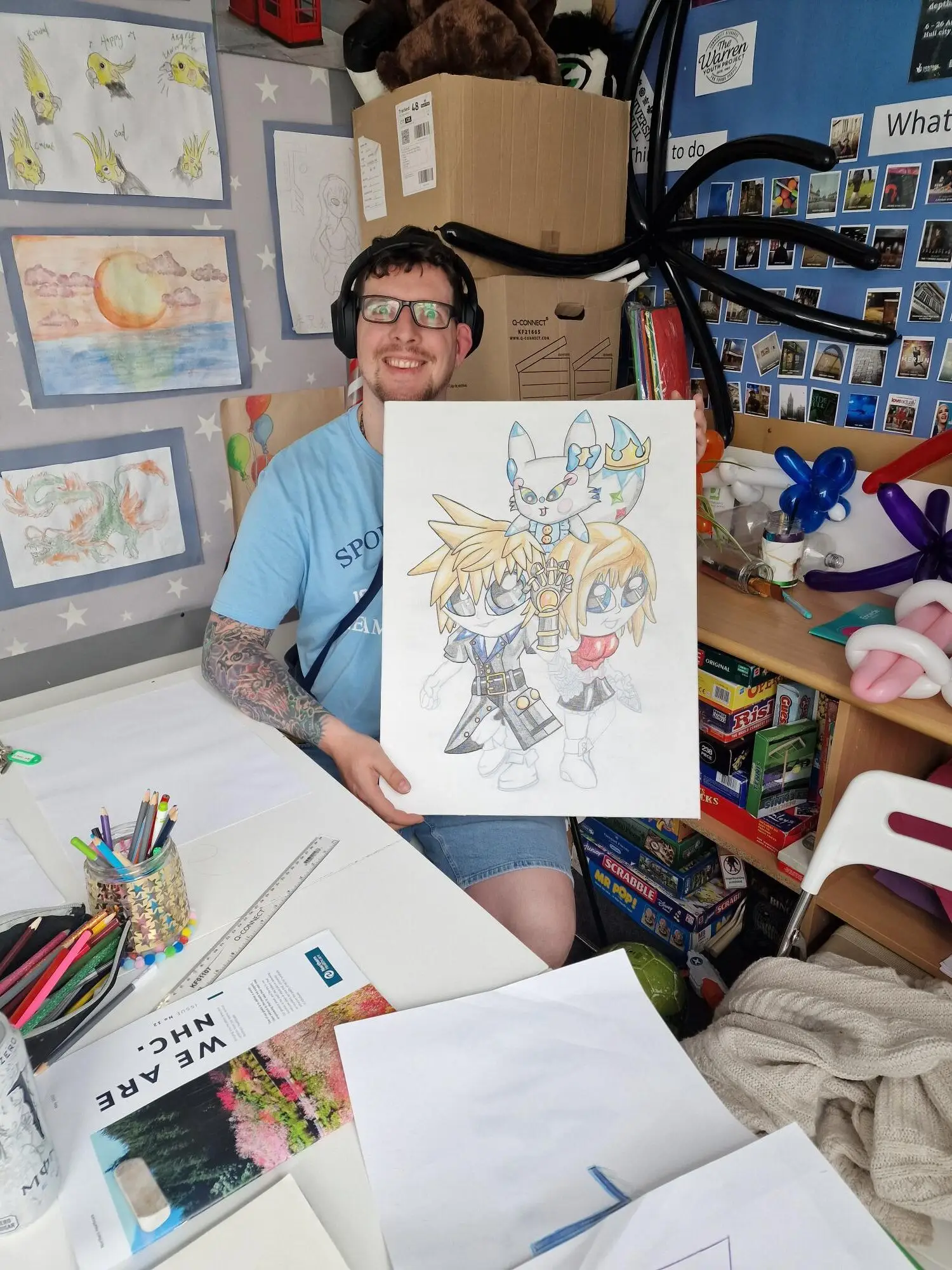 male holding up artwork