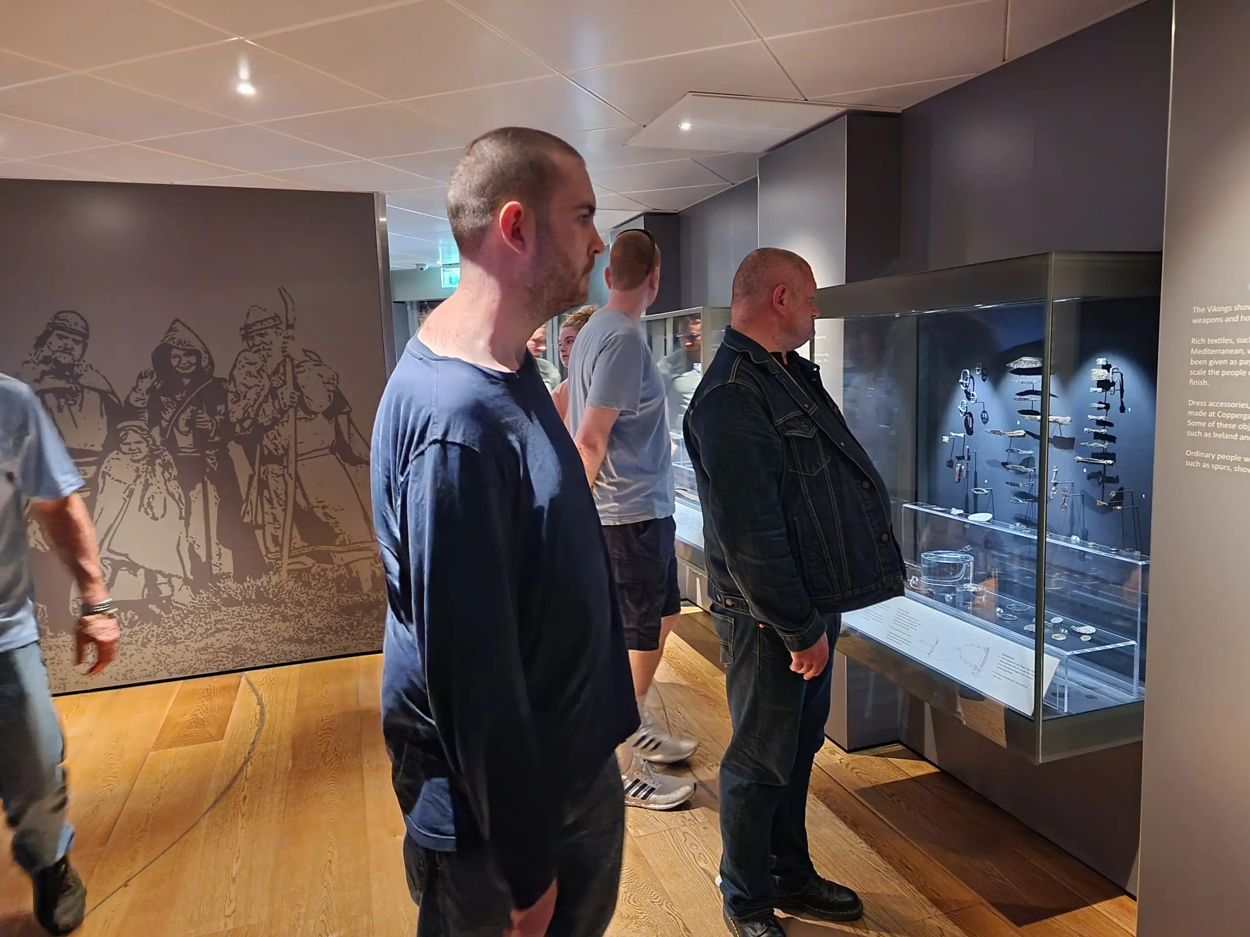 several residents looking at museum displays