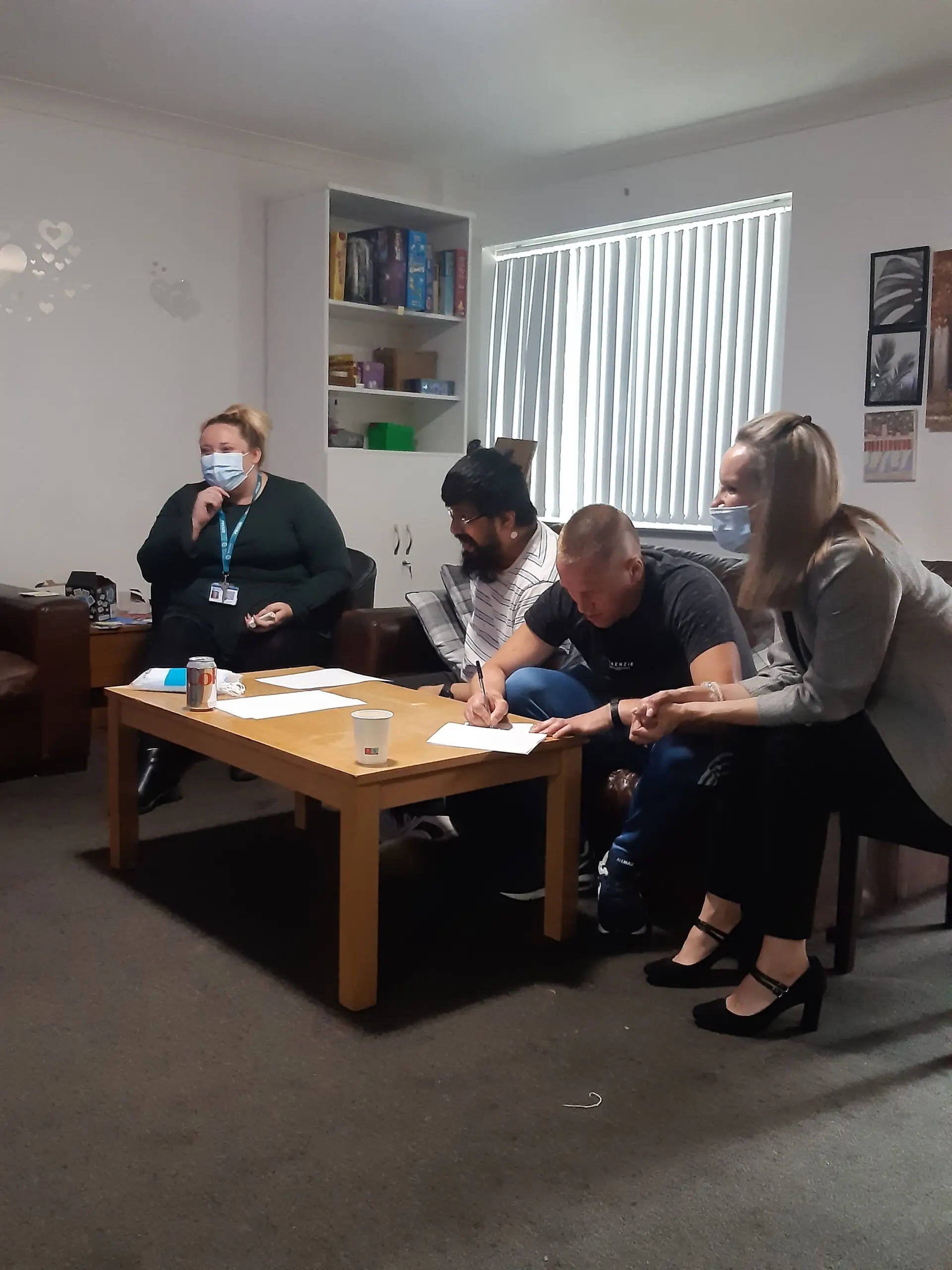 team members and residents writing down quiz question answers in group