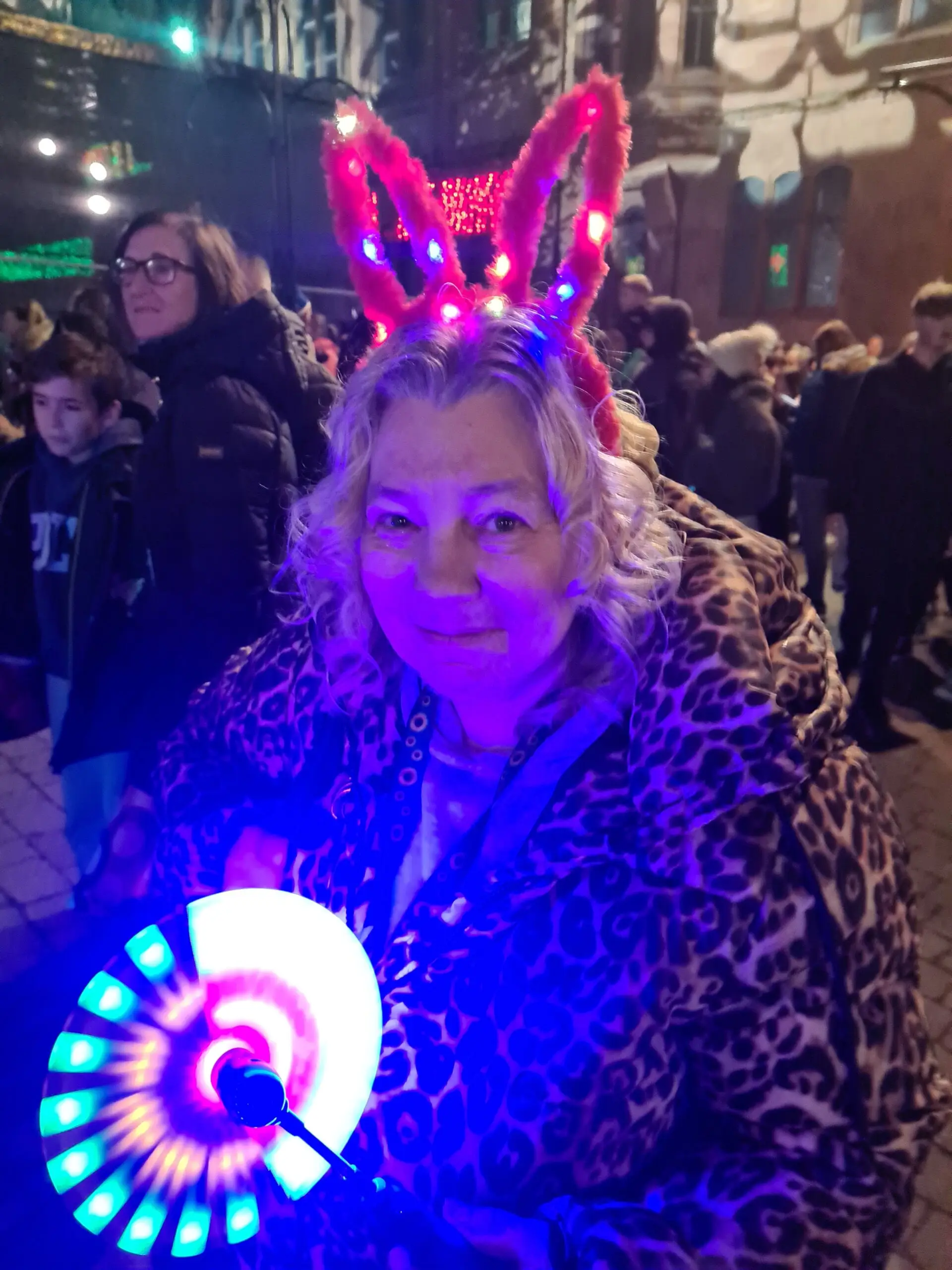 resident in light up headband, holding light up wheel