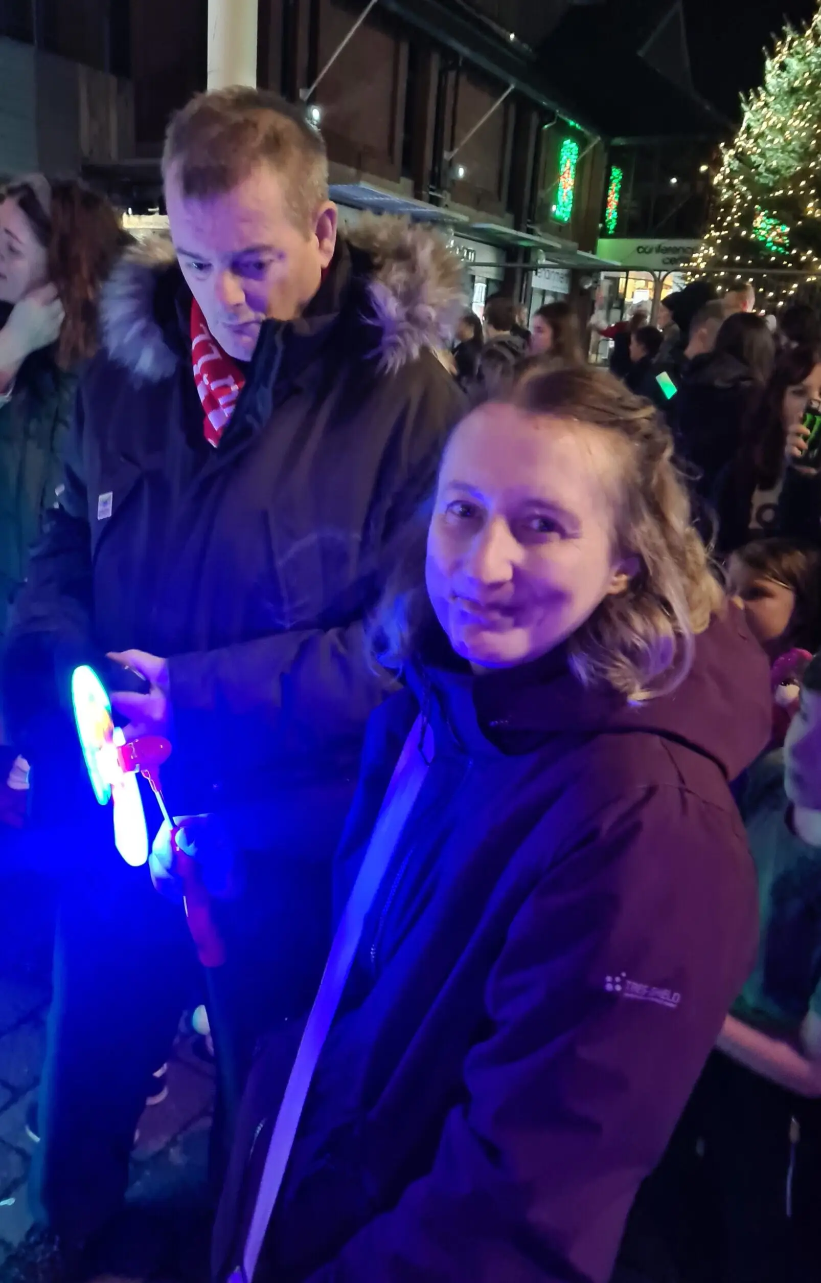 residents holding light up accessories