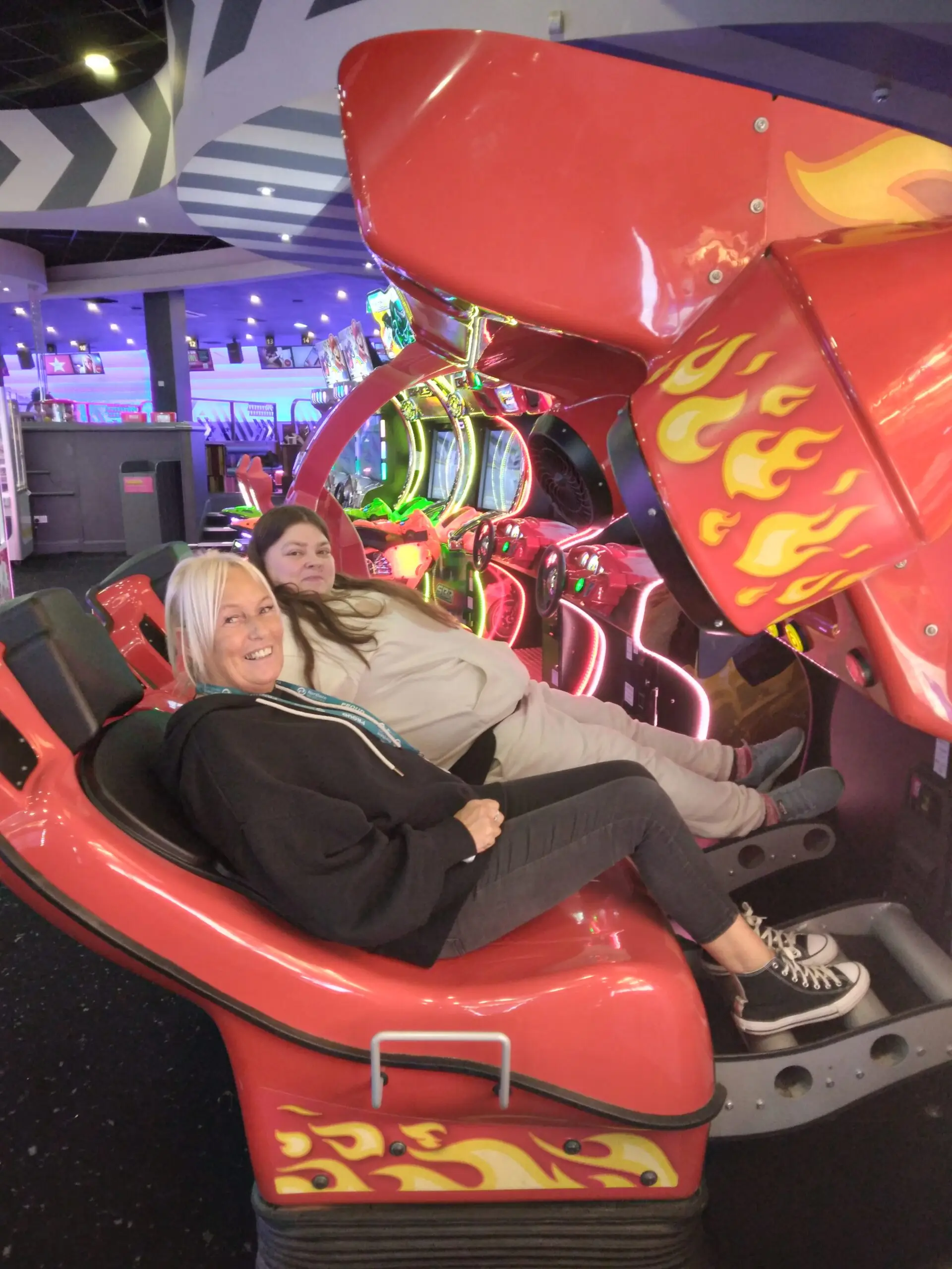 people sitting on seat arcade racing game