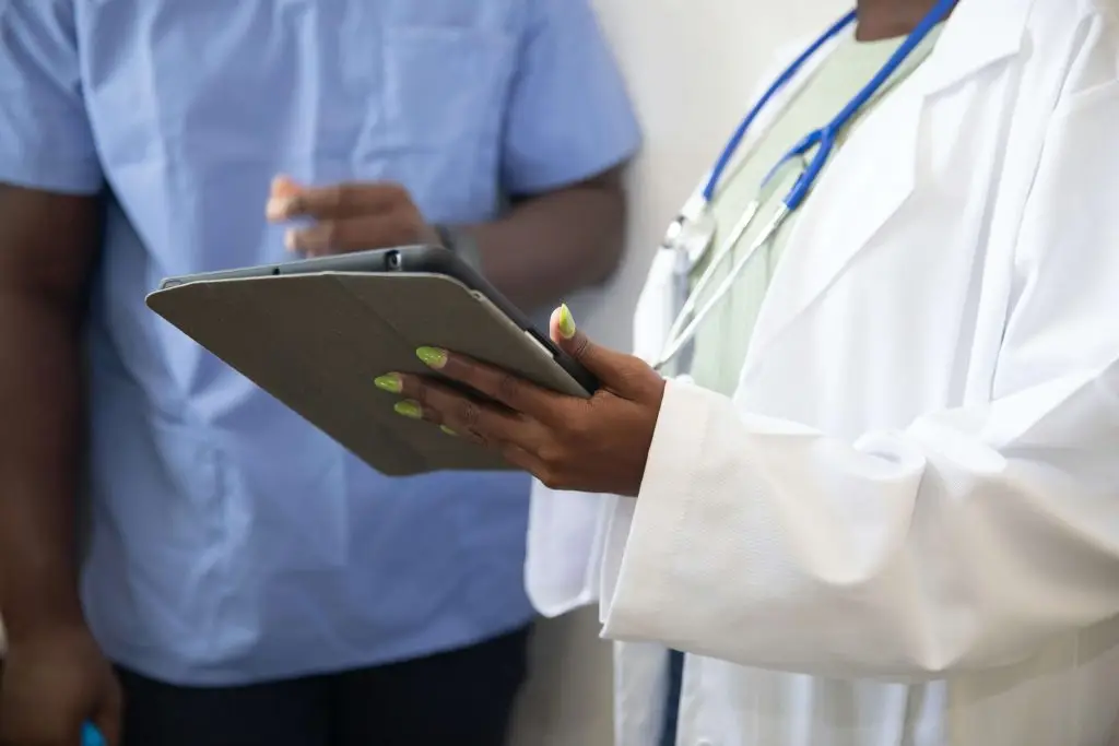 Medical staff looking at a tablet for a blog on what happens after a Section 117 aftercare placement ends