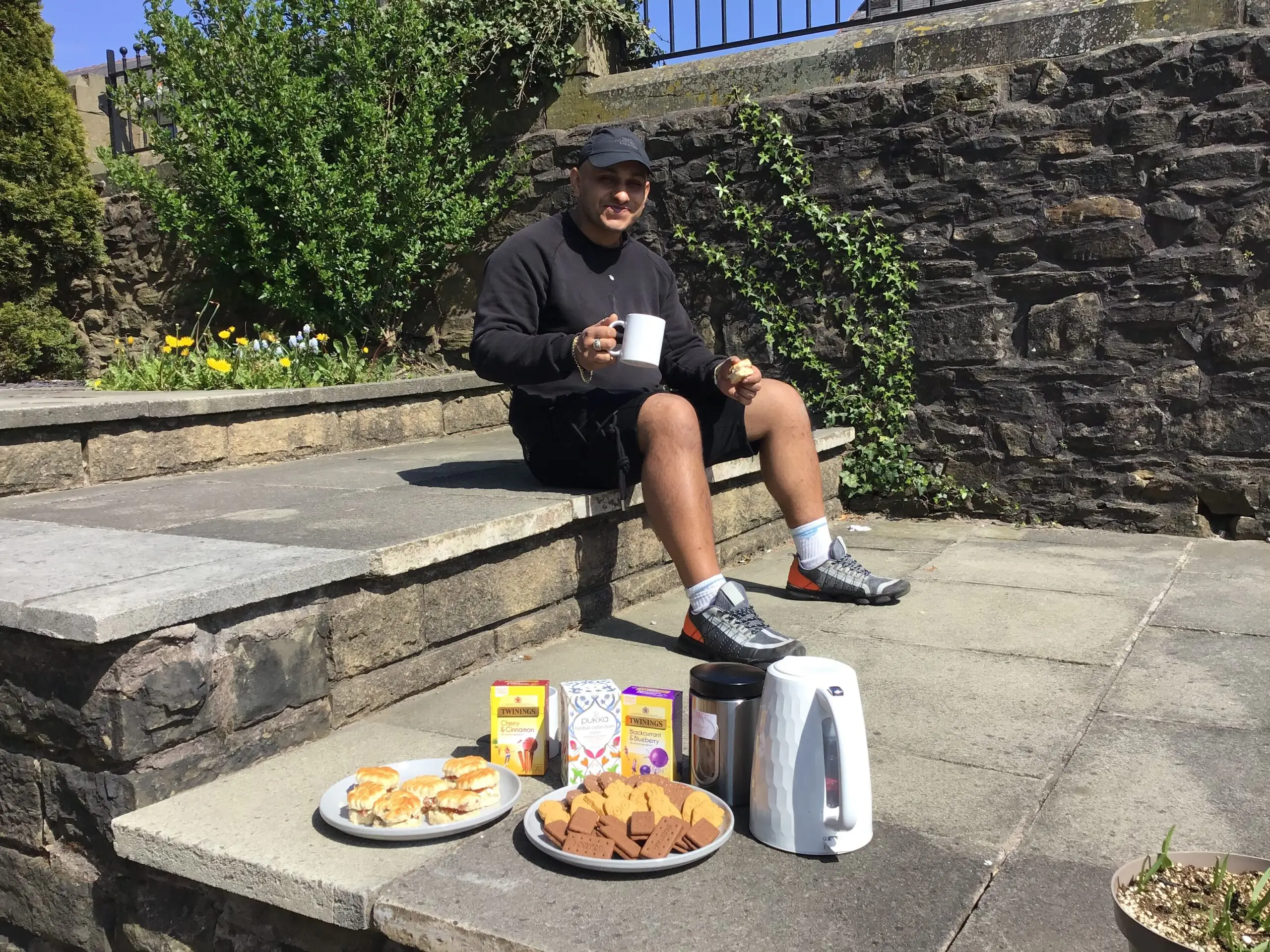 resident enjoying tea and biscuits outdoors