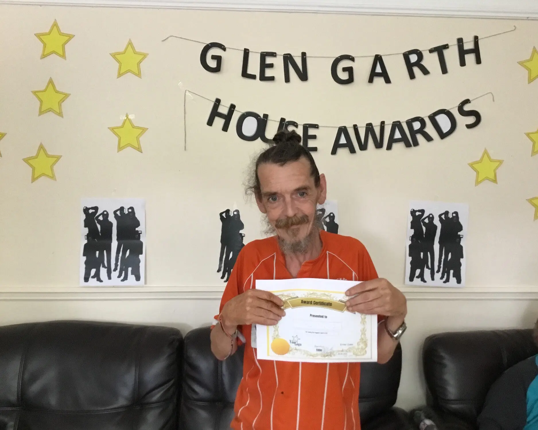 resident with award certificate