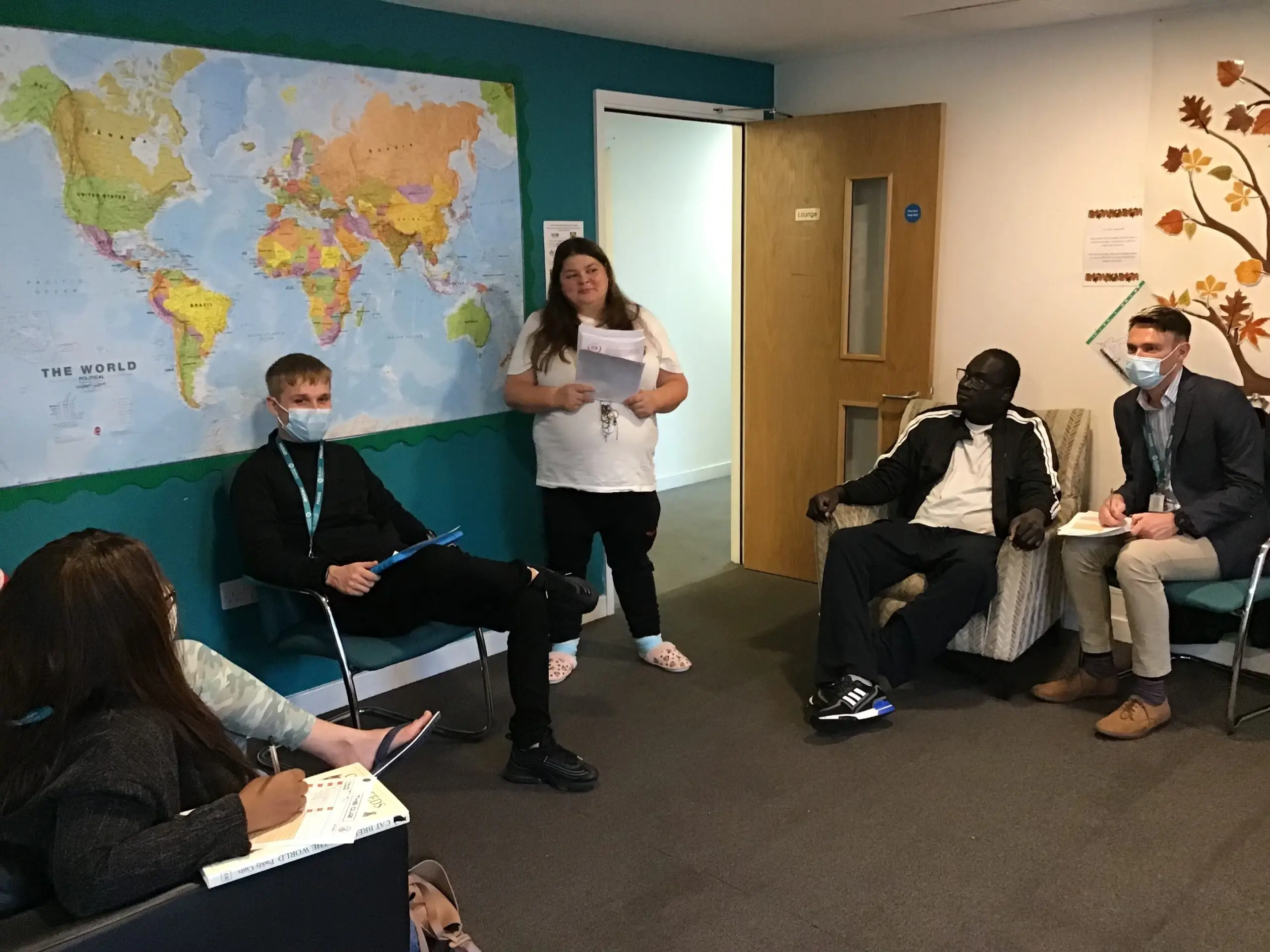 resident hosting a quiz to group of people