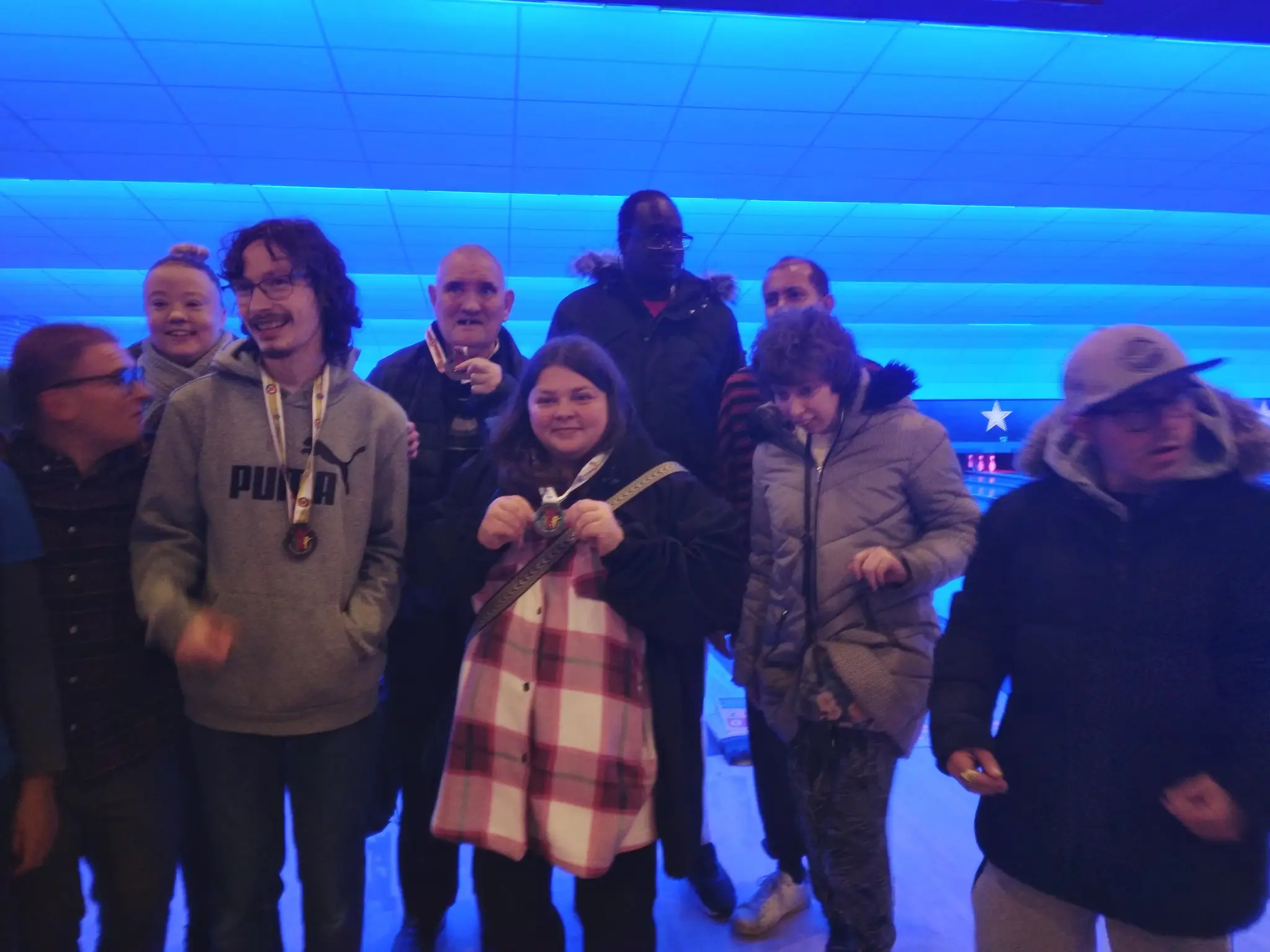 Residents in front of a bowling alley