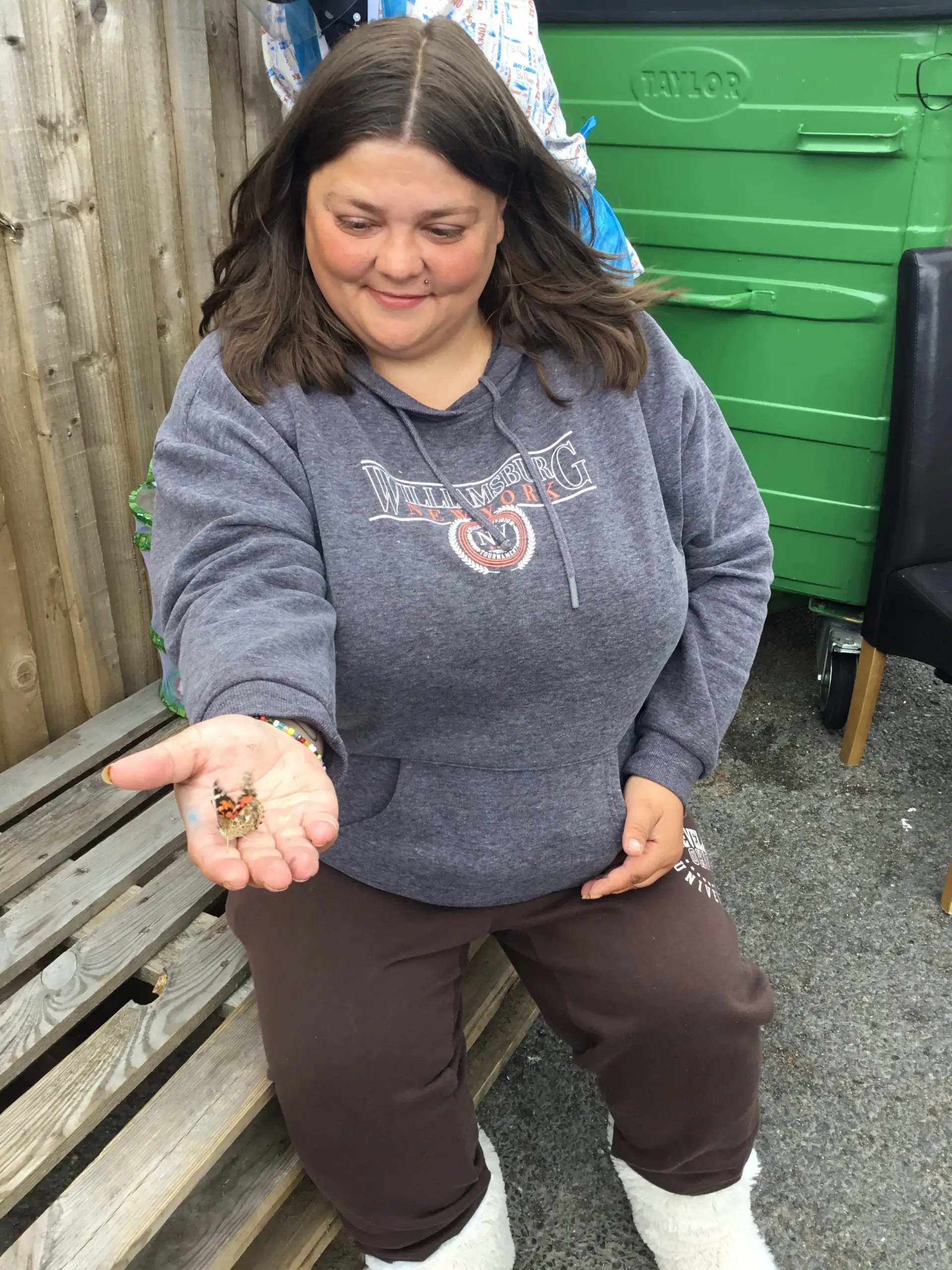 resident with butterfly on open palm