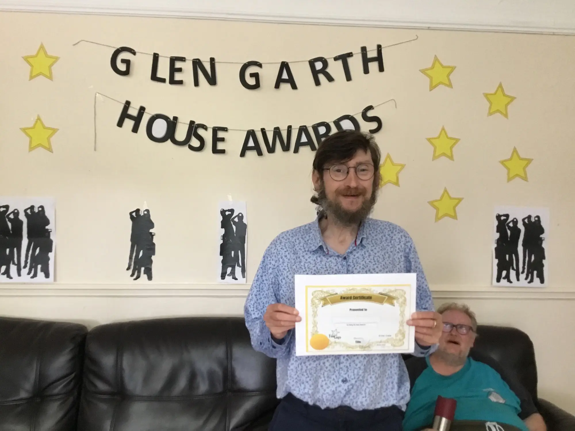 resident with award certificate