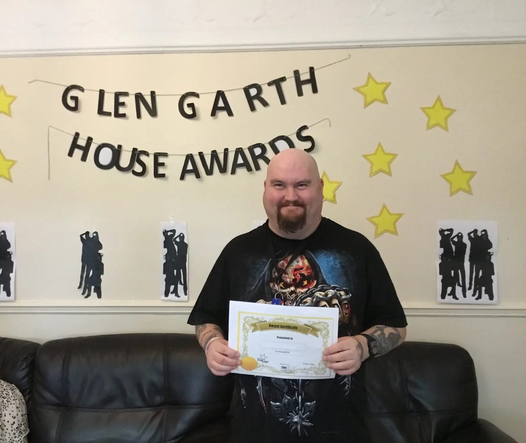 resident with award certificate