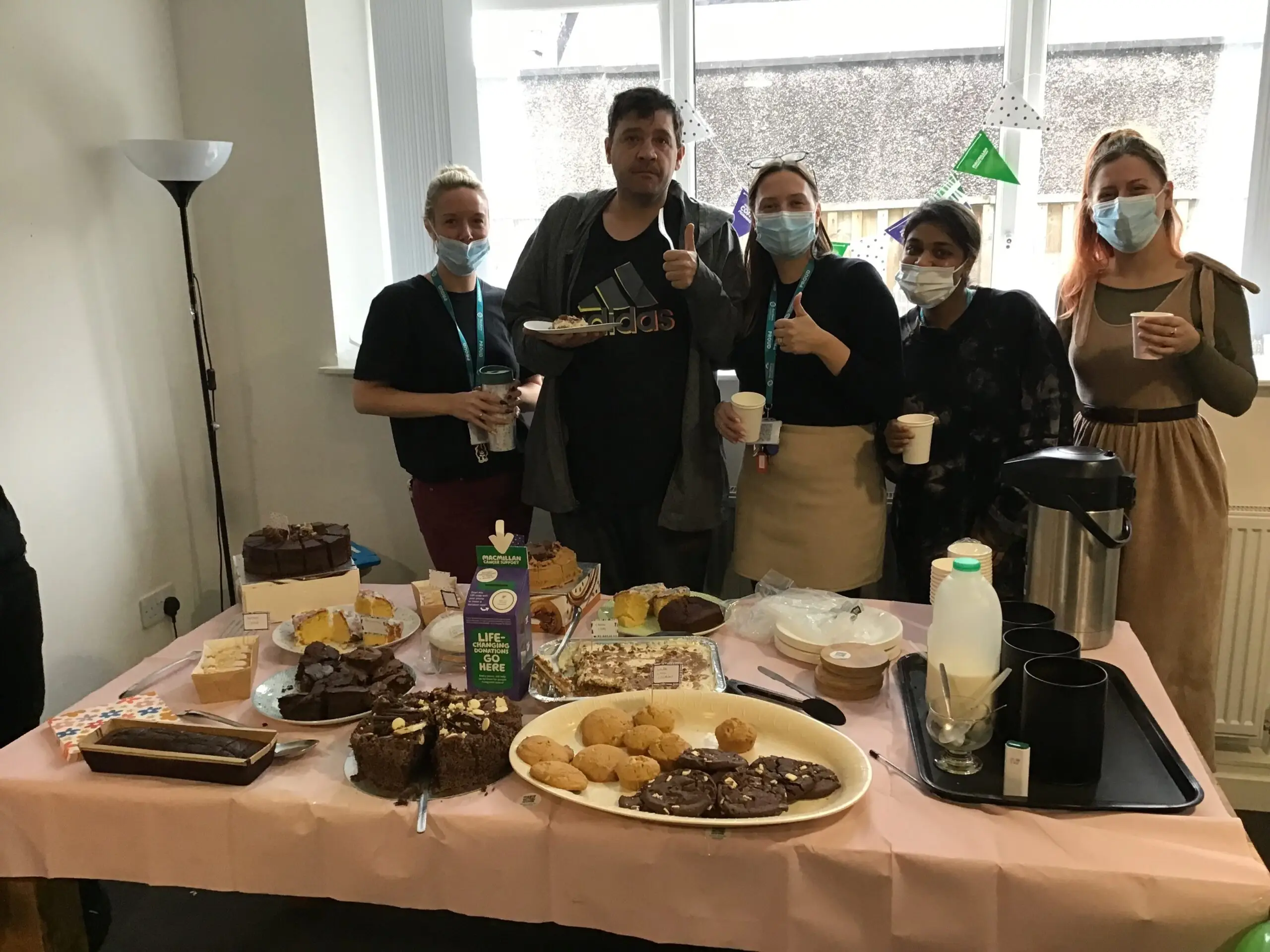 team members standing behind buffet table